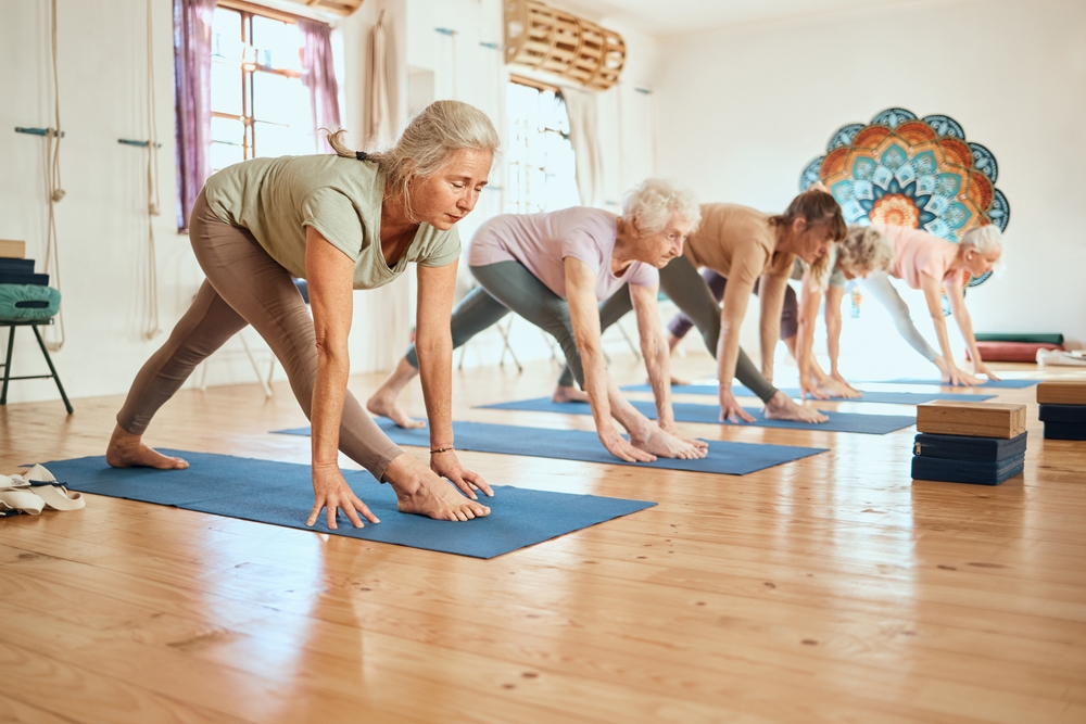 Group of senior woman doing a yoga class at a carefree communities Norwalk