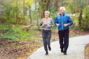 A senior couple going for a jog around the park